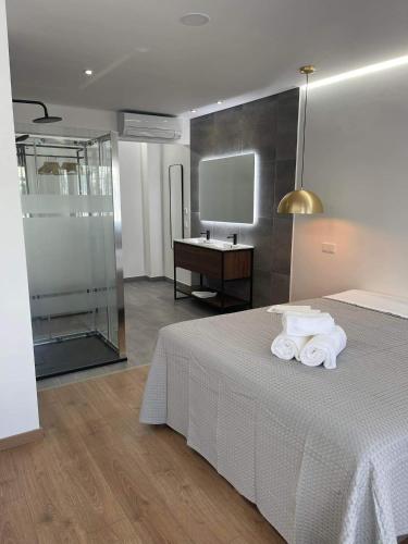 a bedroom with a bed with towels on it at Pontinha Exclusive House in Faro