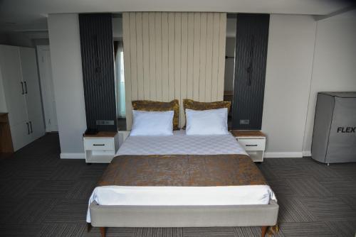 a bedroom with a large bed with two pillows at çepnis hotel in Samsun
