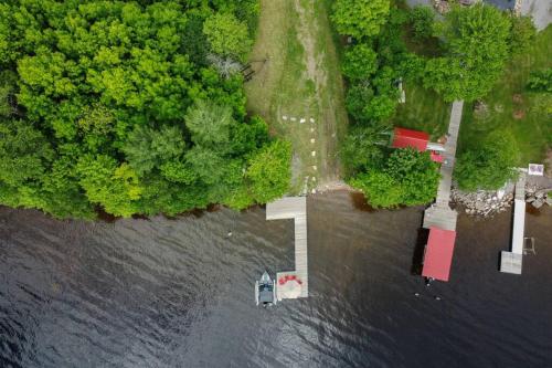 an aerial view of a house in the middle of the water at Private Off Grid Chalet Nestled in Nature With Waterfront Access Near Algonquin Park in Barrys Bay