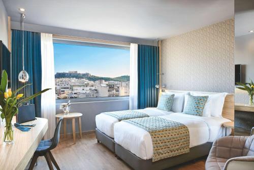 Ένα ή περισσότερα κρεβάτια σε δωμάτιο στο Wyndham Grand Athens