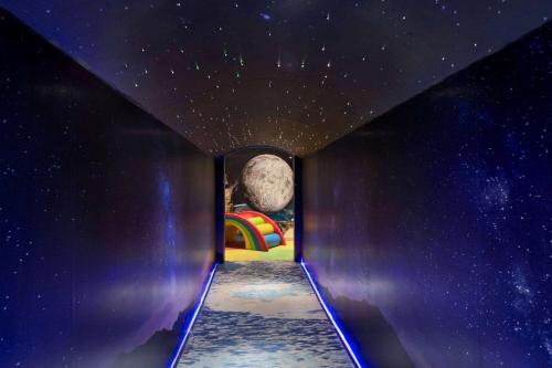 a room with a painting of the moon and a rainbow at Wyndham Grand Manama in Manama