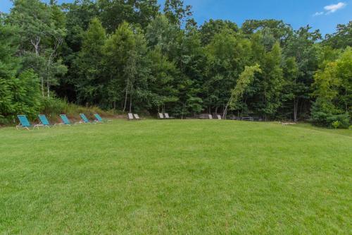 a group of lawn chairs sitting in a field at All Seasons Inn & Suites in Smithfield