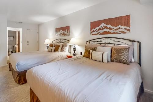 a bedroom with two beds and two lamps at Park Station Condominiums 234 in Park City