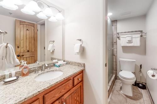 a bathroom with a sink and a toilet and a mirror at Park Station Condominiums 234 in Park City