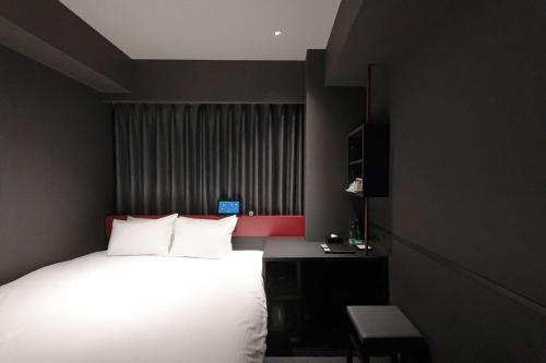 Ένα ή περισσότερα κρεβάτια σε δωμάτιο στο Wyndham Garden Sapporo Odori