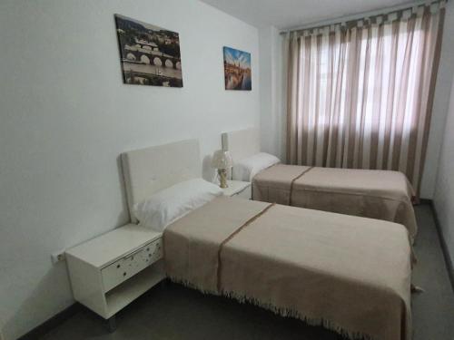 una habitación de hotel con 2 camas y una silla en Sunny apartment Benidorm, en Cala de Finestrat