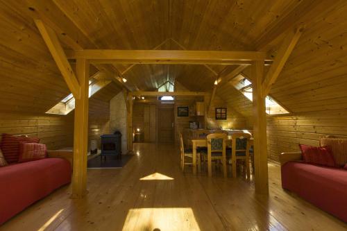 a large wooden room with a table and chairs at Ranch Jelov Klanac in Rakovica