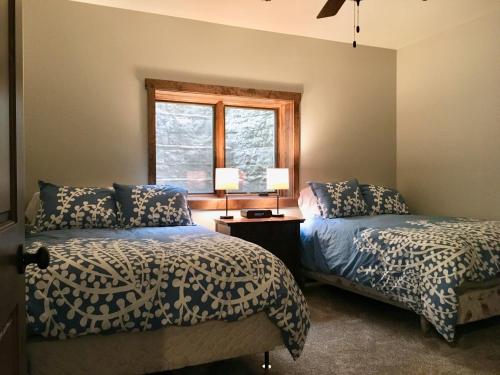 a bedroom with two beds and a window at Lakefront Home 4 Bedroom 4 Bath Sleeps 12 in Waupaca