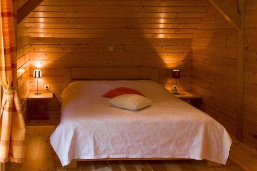 a bedroom with a bed in a wooden cabin at Ranch Jelov Klanac in Rakovica
