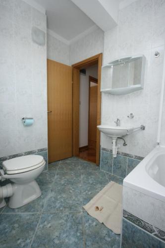a bathroom with a toilet and a sink at Apartment Pag 6311c in Pag