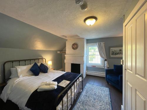a bedroom with a large bed and a fireplace at Stone Hearth Inn and Eatery in Chester