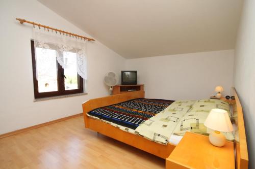 a bedroom with a bed and a table and a window at Apartments with a parking space Novigrad - 7037 in Novigrad Istria