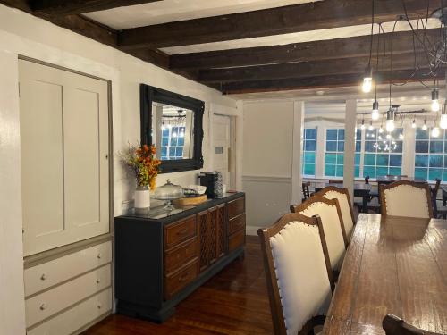 a kitchen with a wooden table and a dining room at Stone Hearth Inn and Eatery in Chester