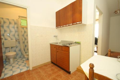 a kitchen with a sink and a toilet at Apartment Labin 7468b in Labin