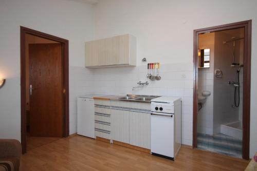 a small kitchen with a sink and a stove at Apartments with a parking space Vodice - 7604 in Vodice