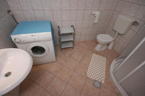 a bathroom with a washing machine and a sink at Apartments by the sea Pag - 6413 in Pag