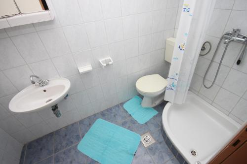 a bathroom with a sink and a toilet and a shower at Apartments by the sea Kustici, Pag - 4129 in Kustići