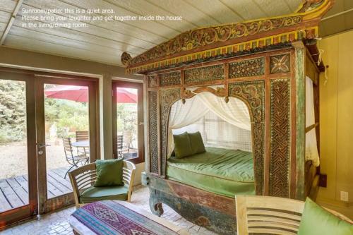 an ornate bed in a room with a patio at Zen Desert, 2BR/2BA Apartment, Private Entrance in Sedona