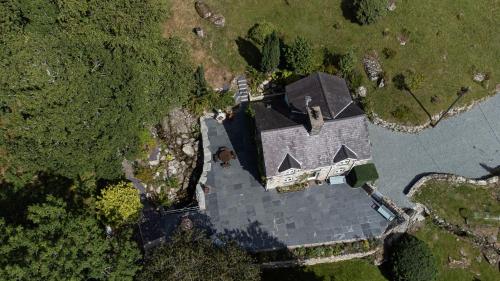 an overhead view of a house with a dog in the yard at Cae Lleci in Dolgellau