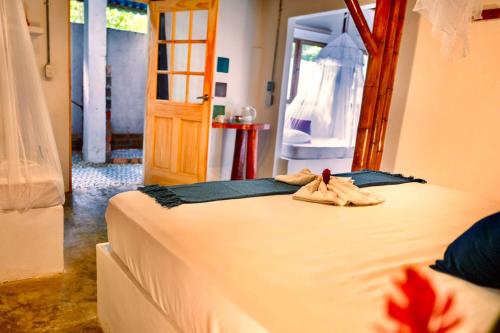 a bedroom with a bed with a toy on it at Kanta Sana in Palomino