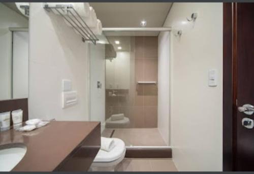 a bathroom with a shower and a toilet and a sink at Hotel Laguetto Stilo Borges - Gramado - semana de 17 a 24 de janeiro de 2026 in Gramado