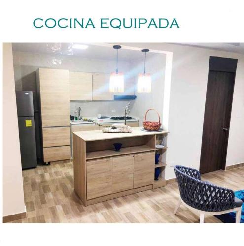 a kitchen with a table and two chairs and a refrigerator at TROPICAL OCEAN SAI in San Andrés