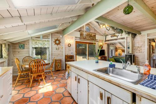 a kitchen with a sink and a table and chairs at Mendocino Dunes - Dune Flower in Fort Bragg