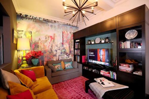 a living room with a couch and a tv at Elegant Norwich Apartment in The Lanes w Parking in Norwich