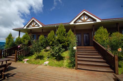 a house with a wooden staircase leading to it at Formosa Vacation Village Homestay in Renai