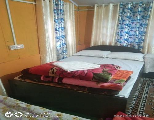a bed in a bedroom with avertisementatronatronstrationstrationstrationstration at Chiten Homestay by StayApart in Sonāda