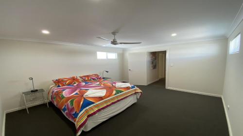 a bedroom with a bed with a colorful comforter at Unit 54 Seafront Estate in Jurien Bay