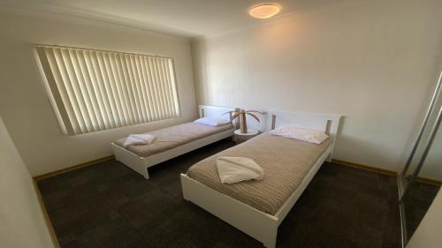 Postel nebo postele na pokoji v ubytování Unit 23 Seafront Estate