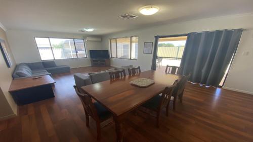 a living room with a table and chairs and a couch at Maniki Gardens in Jurien Bay