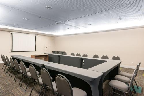 a conference room with a long table and chairs at Apartamento em Hotel Beira Mar de Boa Viagem in Recife