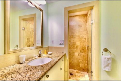 a bathroom with a sink and a shower at La Vista Azul - Lovely Spacious Condo close to Grace Bay - Free Wi-Fi in Turtle Cove