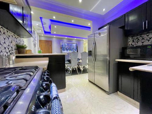 a kitchen with a stainless steel refrigerator and a stove at Apartamento en Residencial Privado in San Isidro