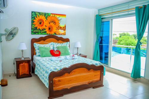a bedroom with a large bed and a large window at Hotel Flor Gloria in Palomino