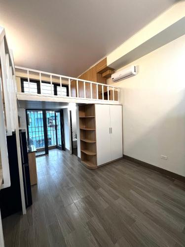 an empty room with a loft bed in a building at Era Apartment Đông Tác in Hanoi