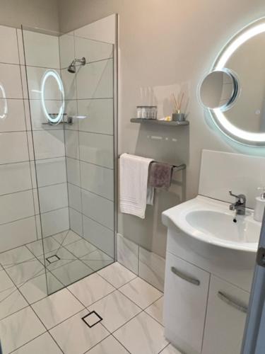 a bathroom with a shower and a sink at Island Bungalow in Bongaree