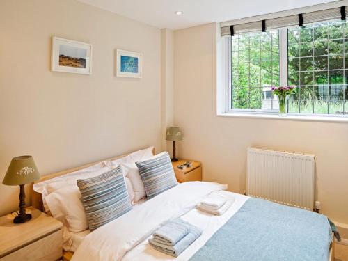 a bedroom with a bed and a window at Headland in St Margarets at Cliff