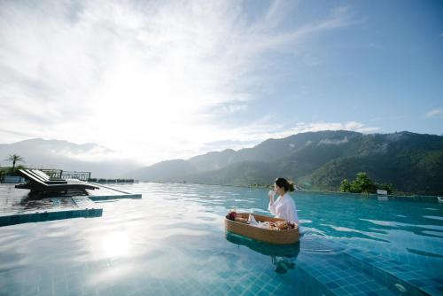 a woman in a boat in the middle of a body of water at Le Grand Pakbeng in Pakbeng