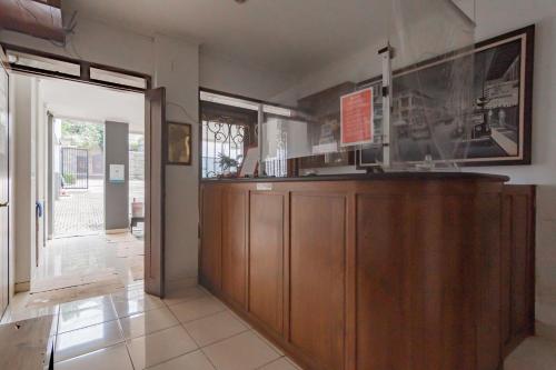 a restaurant with a counter in a room at RedDoorz at Dago Asri 3 in Bandung