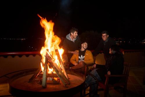 people standing around a fire pit at Casa Andina Premium Puno in Puno