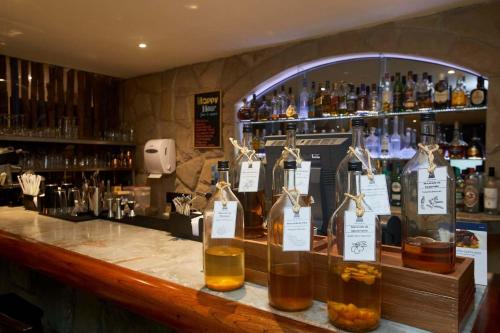 a bar with bottles of whiskey on a counter at Casa Andina Premium Puno in Puno