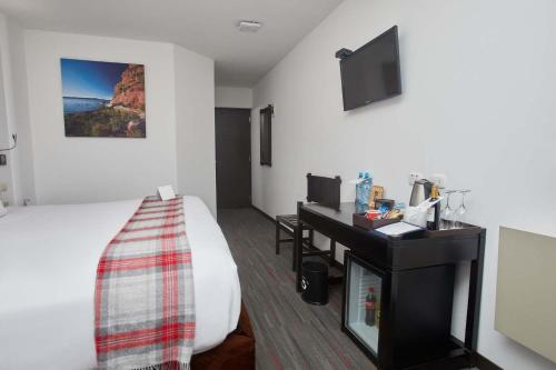 a hotel room with a bed and a desk at Casa Andina Premium Puno in Puno