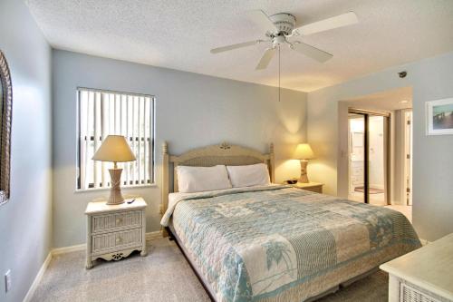 a bedroom with a bed and a ceiling fan at Emerald Isle 204 in St. Pete Beach