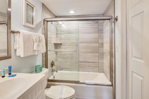 a bathroom with a shower and a toilet and a sink at Emerald Isle 204 in St Pete Beach