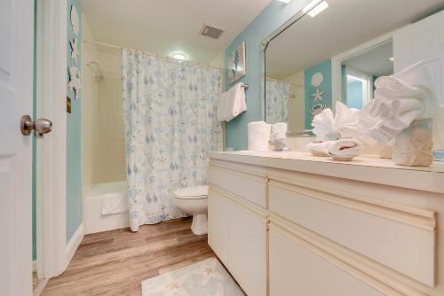 a bathroom with a toilet and a sink and a mirror at Emerald Isle 603 in St Pete Beach