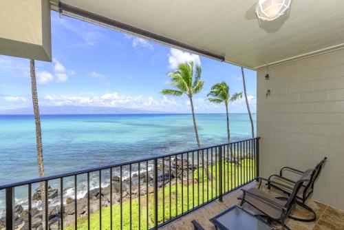 a balcony with a view of the ocean at Noelani 304 in Kahana