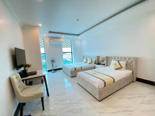 a bedroom with a bed and a desk and a couch at KHÁCH SẠN PHƯƠNG MINH in Hai Phong